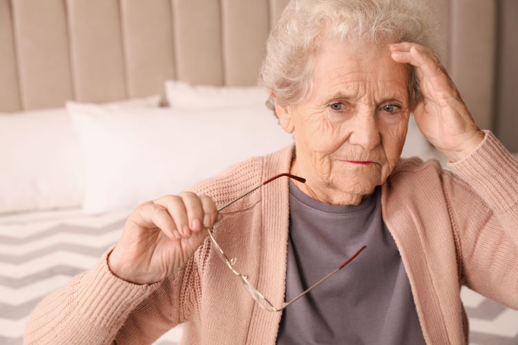 Older senior woman confused at home, struggling with symptoms of dementia or alzheimer's